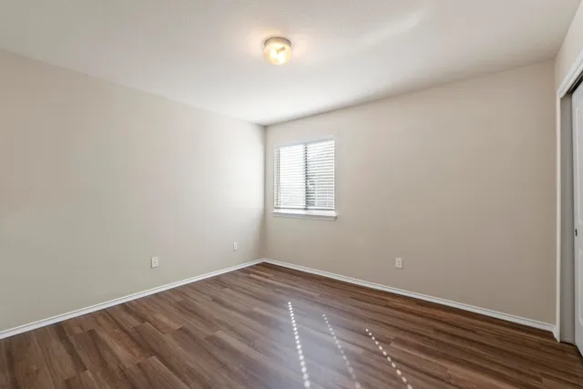a view of room with wooden floor and fan