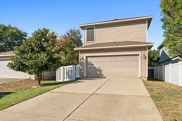a view of backyard of house with green space