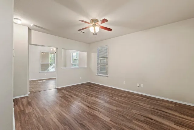 wooden floor in an empty room with a window