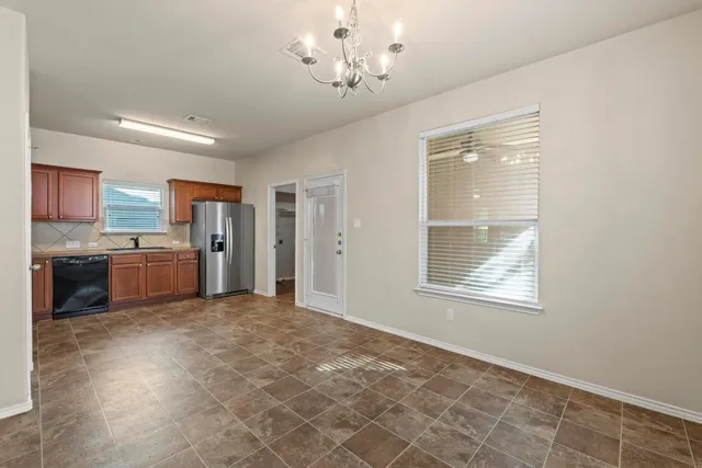 a view of a kitchen with a sink cabinet and a window