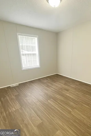 an empty room with wooden floor