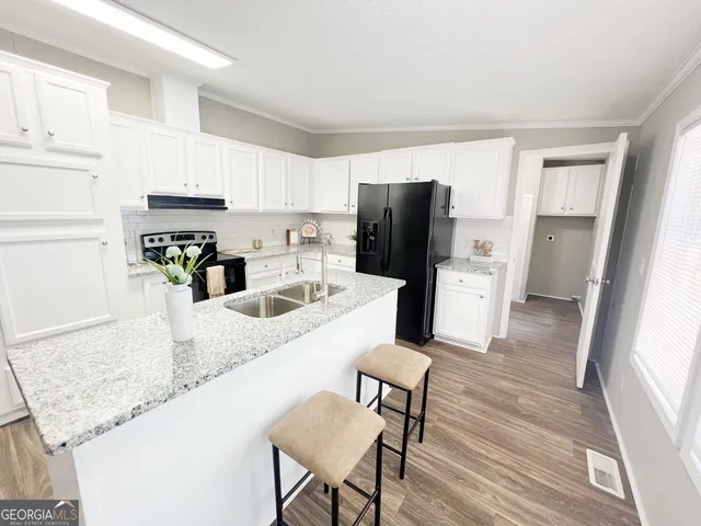 a view of an empty room with wooden floor