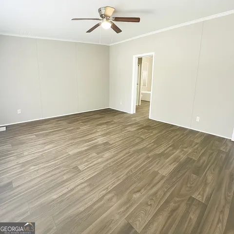 a large white bathroom with a double vanity sink a mirror and a bathtub