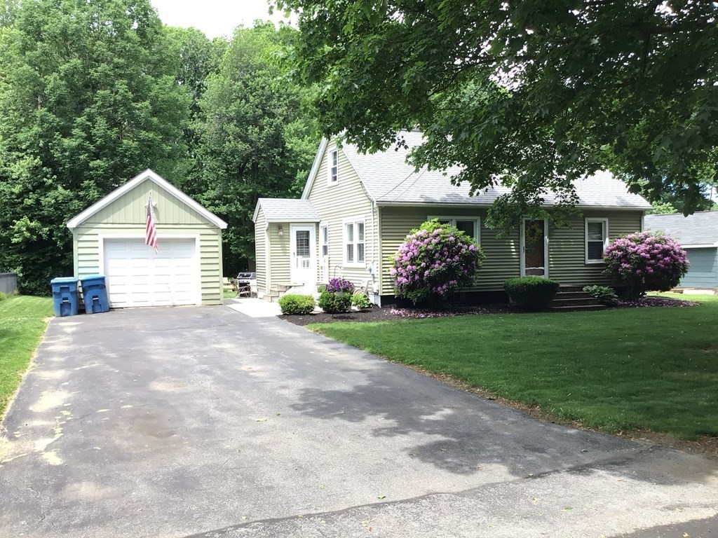 9 Inwood Road Rutland, MA 01543 - Photo 1 of 22 a front view of a house with a garden and plants