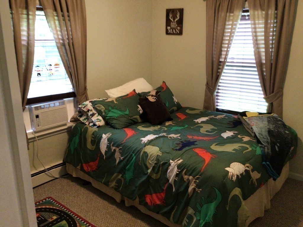 9 Inwood Road Rutland, MA 01543 - Photo 8 of 22 a bed sitting in a bedroom next to a window