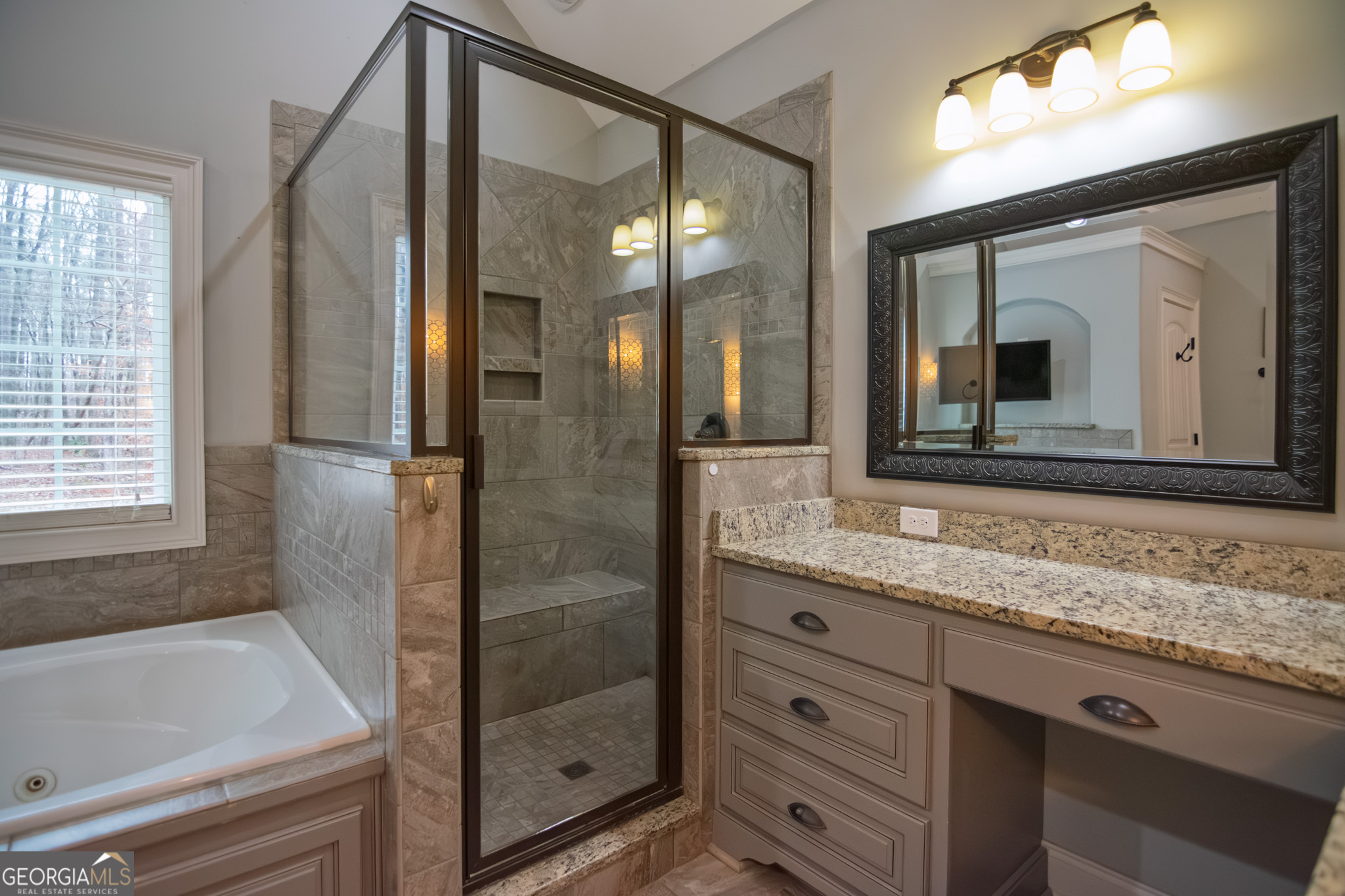 3337 Lower Blue Springs Road Hamilton, GA 31811 - Photo 17 of 41 a bathroom with a granite countertop sink mirror and shower