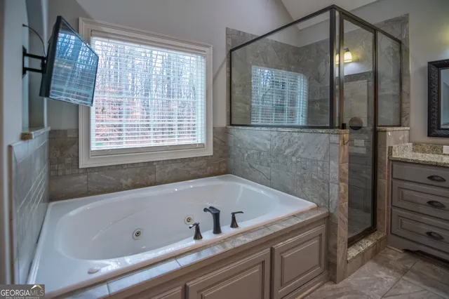 a bathroom with a tub and a shower
