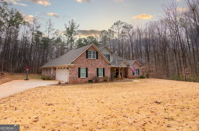 a front view of a house with a yard covered in snow