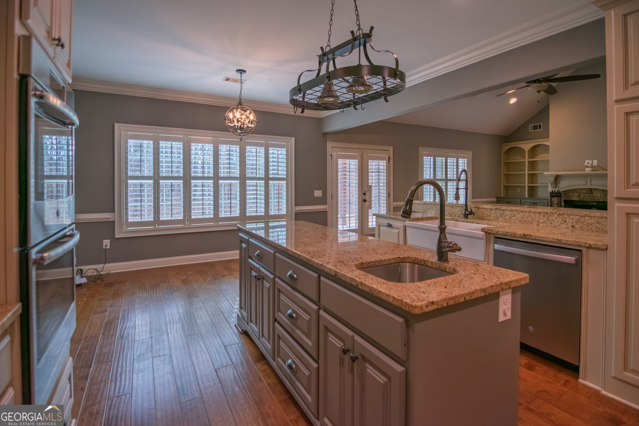 3337 Lower Blue Springs Road Hamilton, GA 31811 - Photo 9 of 41 a kitchen with sink cabinets and wooden floor