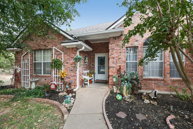 a view of a house with sitting area and garden