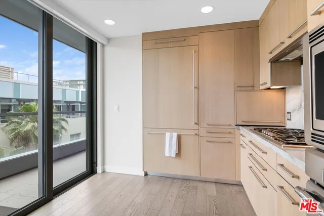 a dining room with furniture and a potted plant