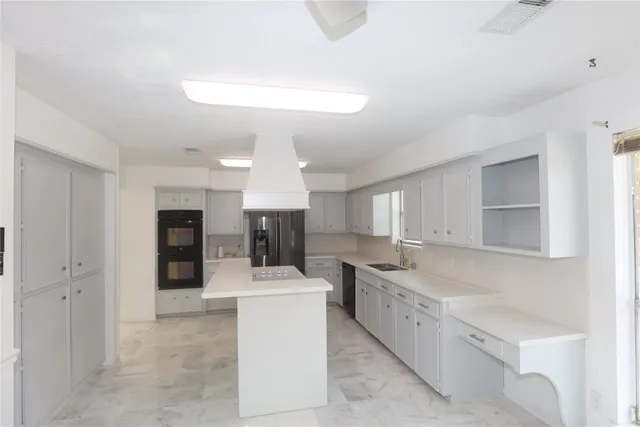a kitchen with refrigerator cabinets and a sink