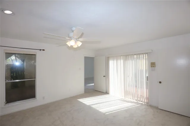 an empty room with a ceiling fan