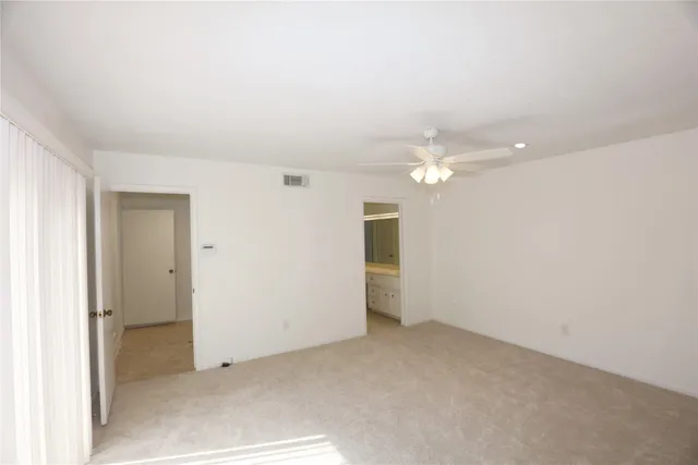 a view of a hallway with a refrigerator
