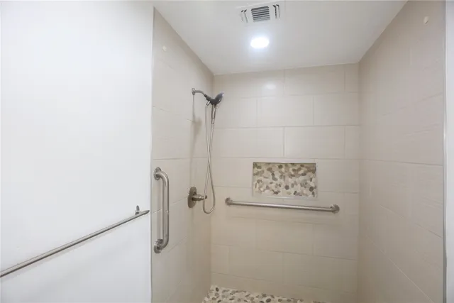 an empty room with a window and a ceiling fan