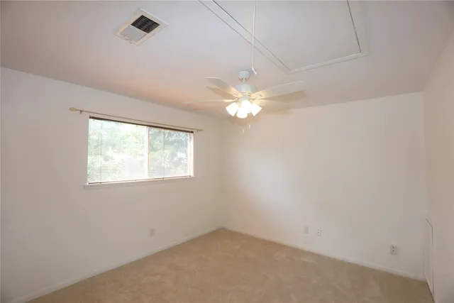 a view of a room with wooden floor and a plant