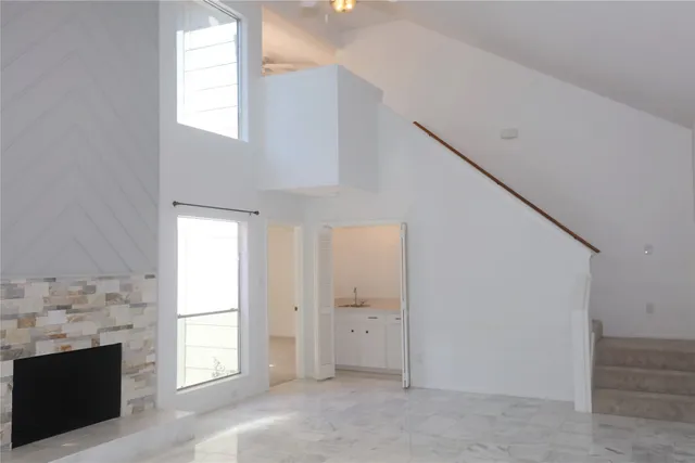 a view of empty room with window and fireplace