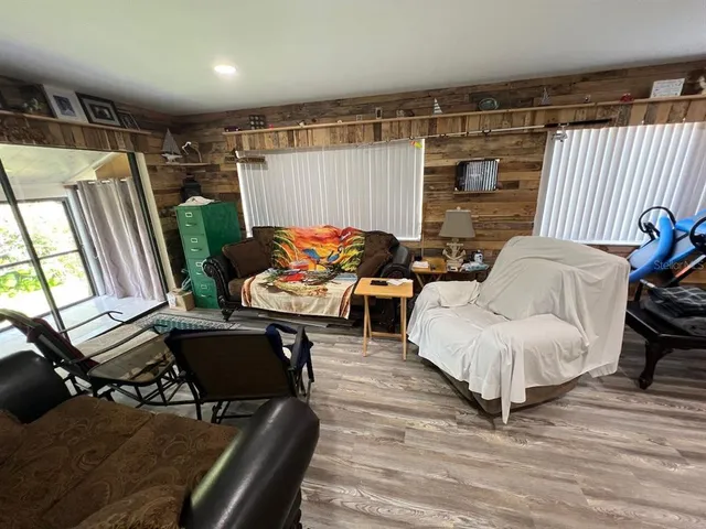 a living room with furniture a flat screen tv and a table