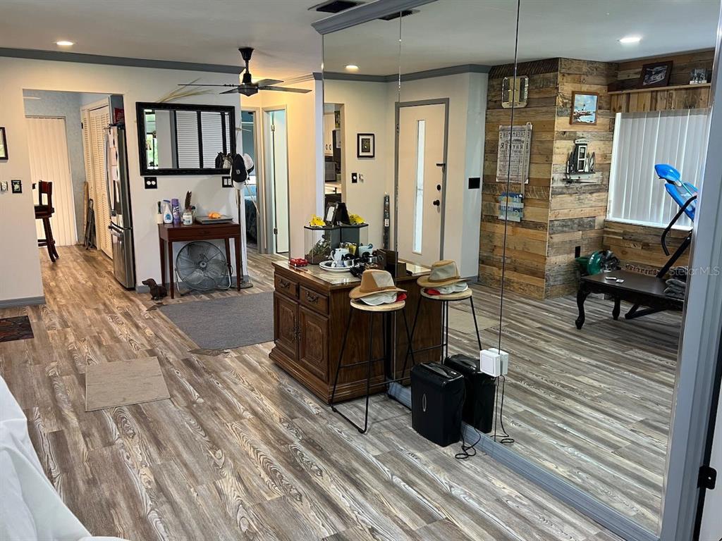 12908 Wedgewood Way, Unit D Hudson, FL 34667 - Photo 12 of 55 a living room with furniture a flat screen tv and a table