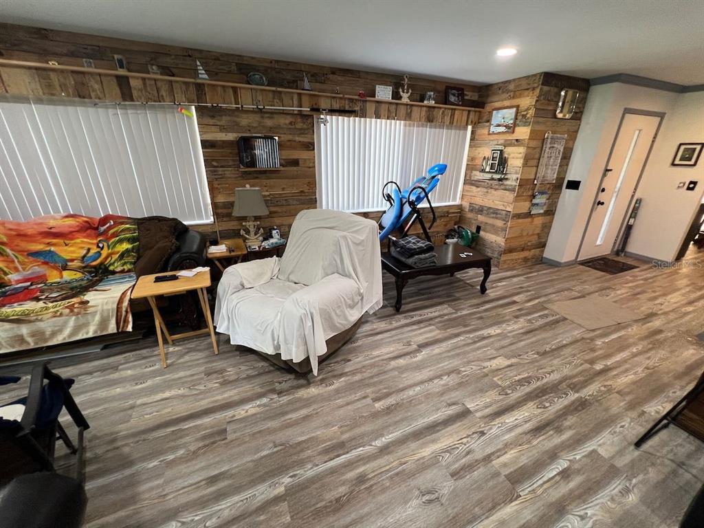 12908 Wedgewood Way, Unit D Hudson, FL 34667 - Photo 14 of 55 a living room with furniture and a wooden floor