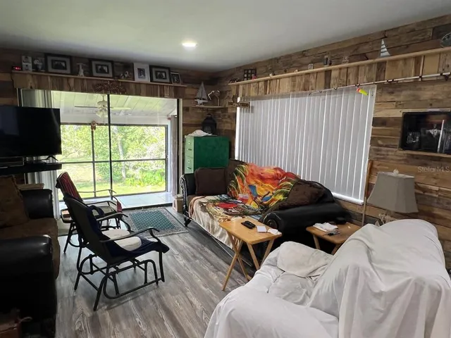 a room with furniture a flat screen tv and a fireplace