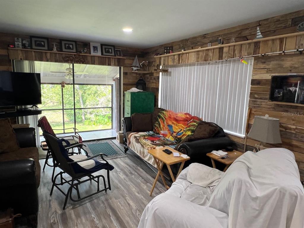 12908 Wedgewood Way, Unit D Hudson, FL 34667 - Photo 16 of 55 a living room with furniture and a flat screen tv