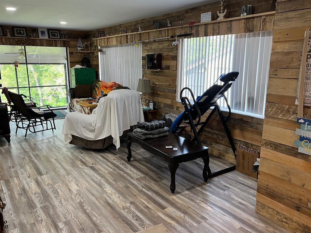 12908 Wedgewood Way, Unit D Hudson, FL 34667 - Photo 19 of 55 a living room with furniture a window and wooden floor
