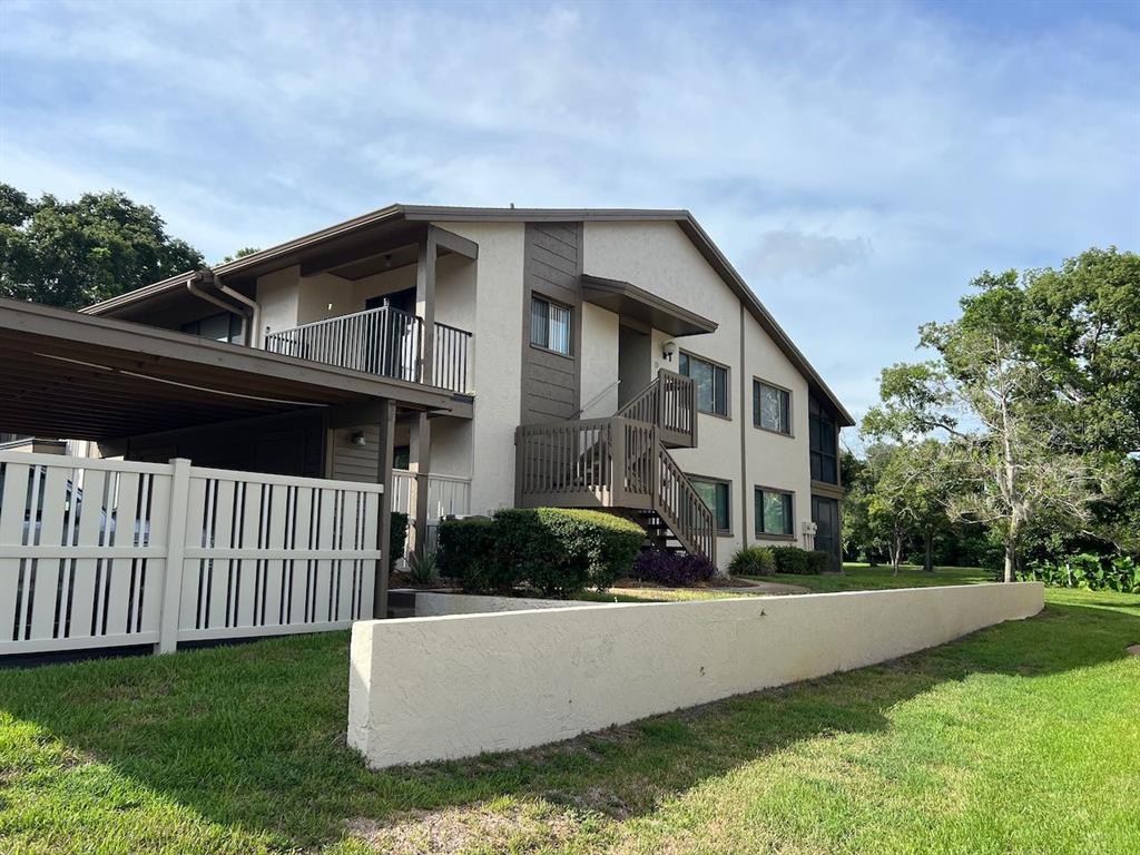 12908 Wedgewood Way, Unit D Hudson, FL 34667 - Photo 2 of 55 a front view of a house with garden