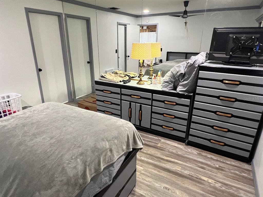 12908 Wedgewood Way, Unit D Hudson, FL 34667 - Photo 21 of 55 a bedroom with a bed and a dresser