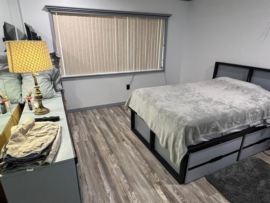 12908 Wedgewood Way, Unit D Hudson, FL 34667 - Photo 22 of 55 a bed sitting in a bedroom next to a window