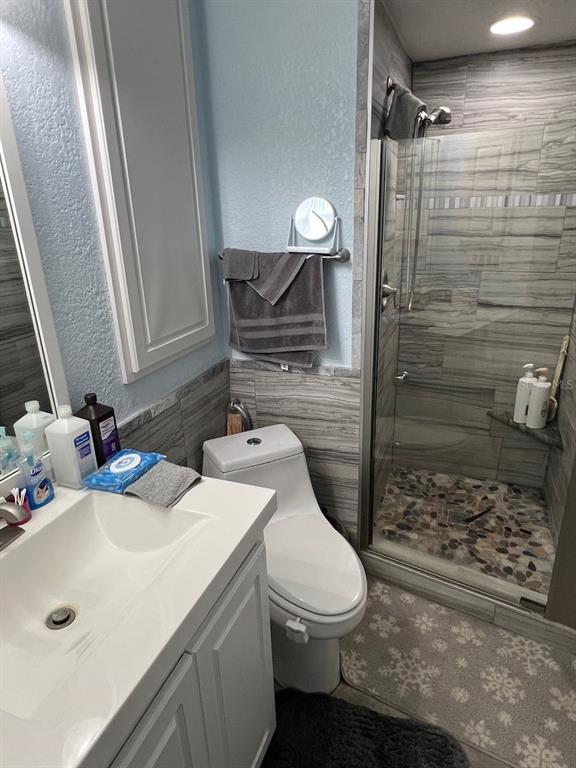 12908 Wedgewood Way, Unit D Hudson, FL 34667 - Photo 25 of 55 a bathroom with a sink toilet and shower