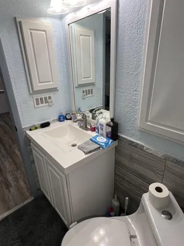 a kitchen with stainless steel appliances a dining table chairs and a refrigerator