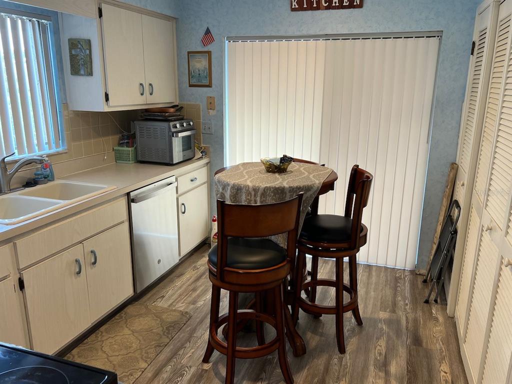 12908 Wedgewood Way, Unit D Hudson, FL 34667 - Photo 28 of 55 a kitchen with stainless steel appliances a dining table chairs and a refrigerator