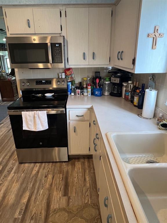 12908 Wedgewood Way, Unit D Hudson, FL 34667 - Photo 30 of 55 a kitchen with stainless steel appliances granite countertop a stove a sink and a microwave