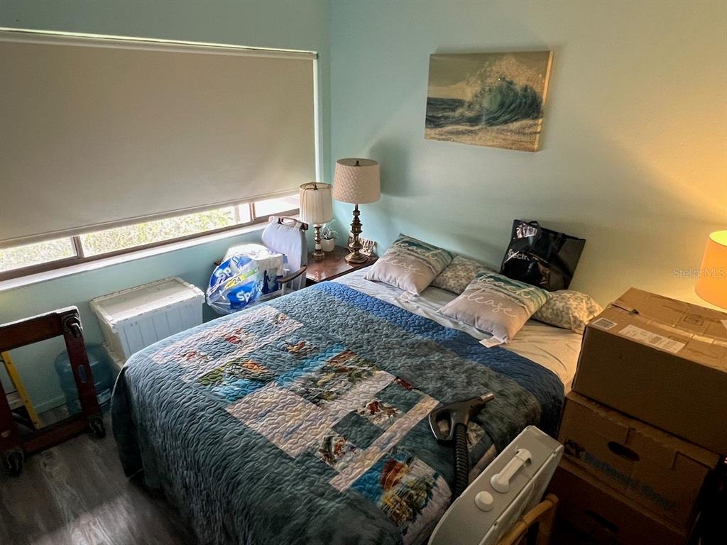 12908 Wedgewood Way, Unit D Hudson, FL 34667 - Photo 35 of 55 a bed sitting in a bedroom next to a window