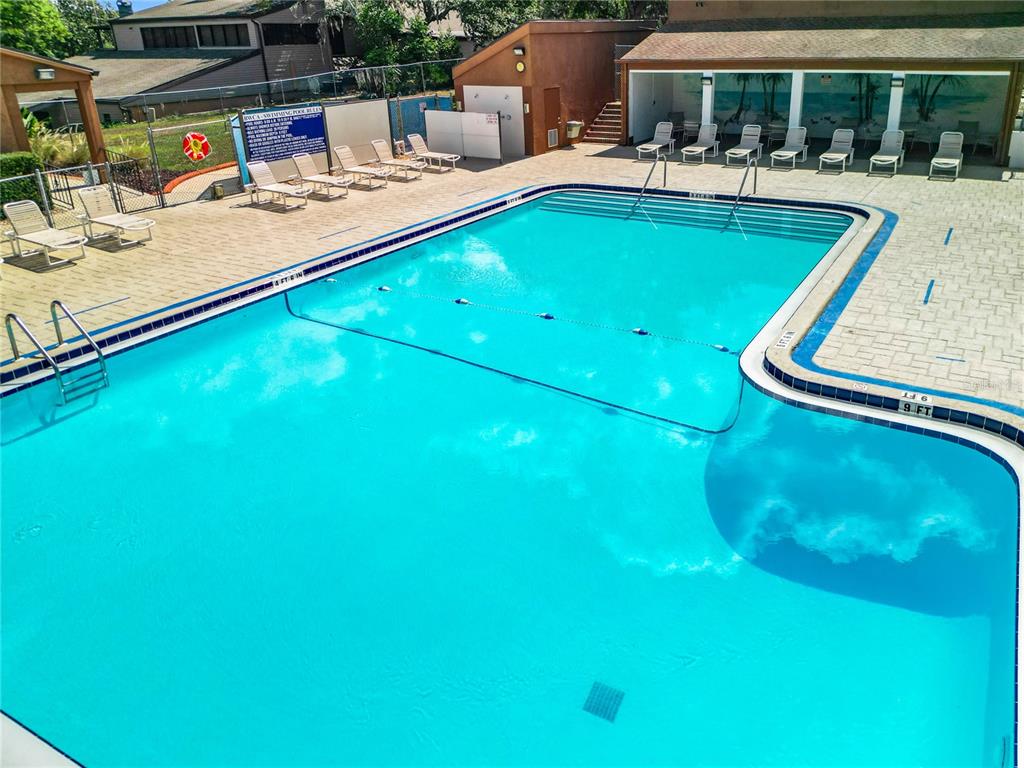 12908 Wedgewood Way, Unit D Hudson, FL 34667 - Photo 52 of 55 a view of a swimming pool with lounge chairs