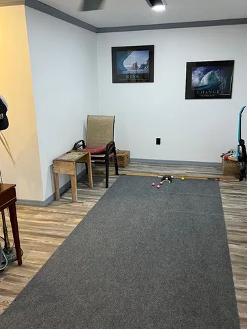 a view of a workspace with furniture and stairs
