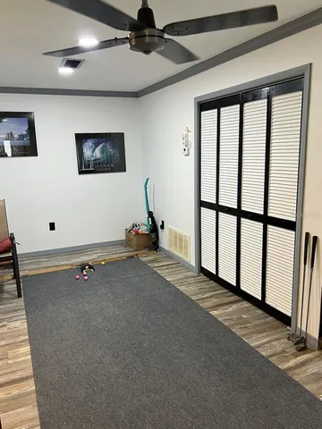 a living room with furniture a flat screen tv and a large window