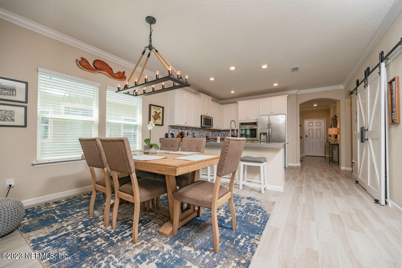 77 Glorieta Drive St. Augustine, FL 32095 - Photo 13 of 67 a view of a dining room with furniture window and wooden floor