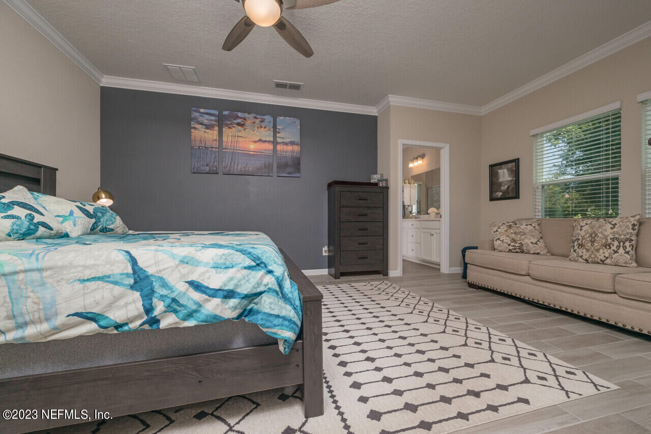 77 Glorieta Drive St. Augustine, FL 32095 - Photo 19 of 67 a bedroom with a bed and a couch