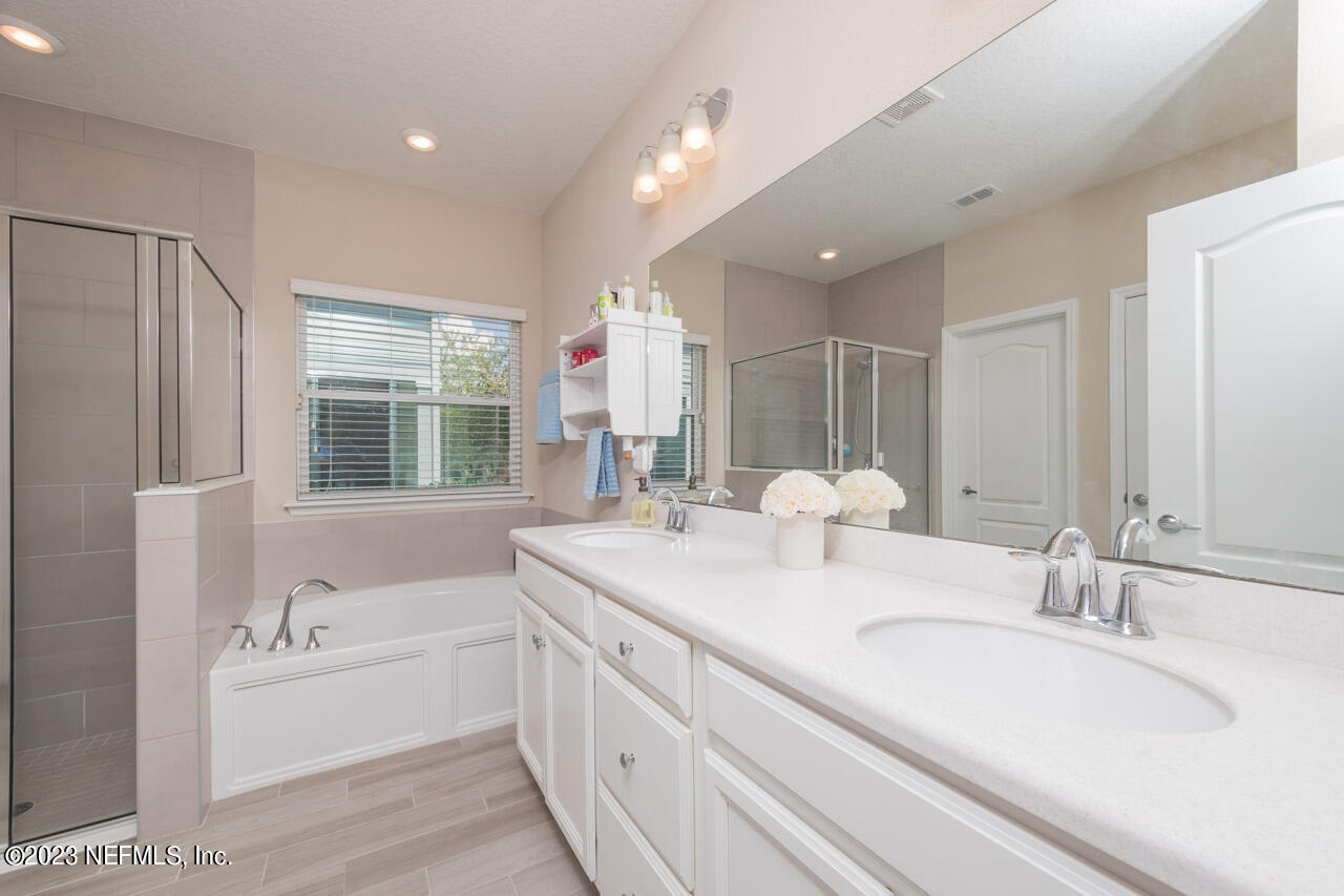 77 Glorieta Drive St. Augustine, FL 32095 - Photo 20 of 67 a bathroom with a granite countertop sink mirror bathtub and double