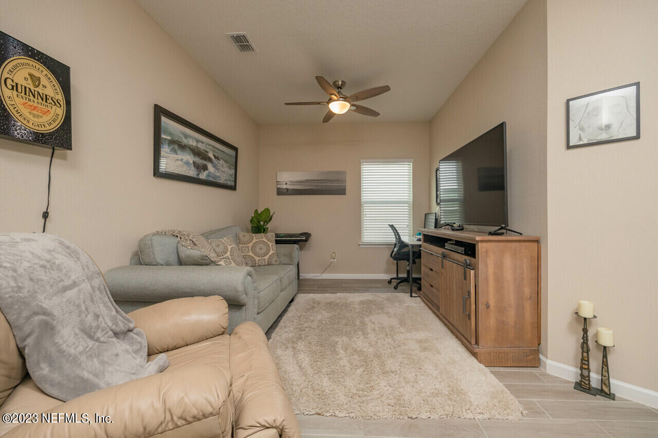 77 Glorieta Drive St. Augustine, FL 32095 - Photo 24 of 67 a living room with furniture and a flat screen tv