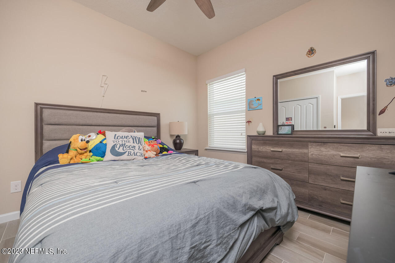 77 Glorieta Drive St. Augustine, FL 32095 - Photo 26 of 67 a bedroom with a bed and a large mirror