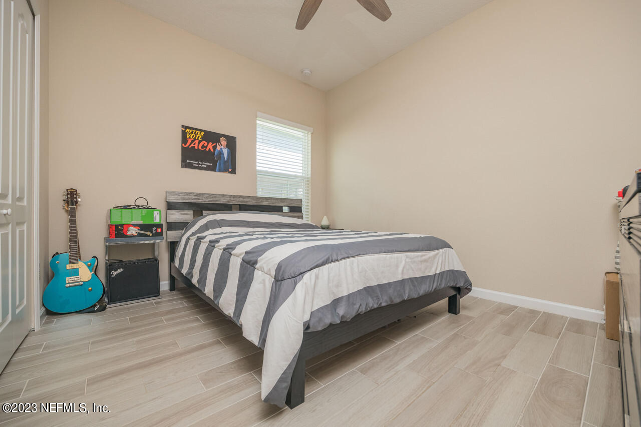 77 Glorieta Drive St. Augustine, FL 32095 - Photo 27 of 67 a bedroom with a bed and painting on the wall
