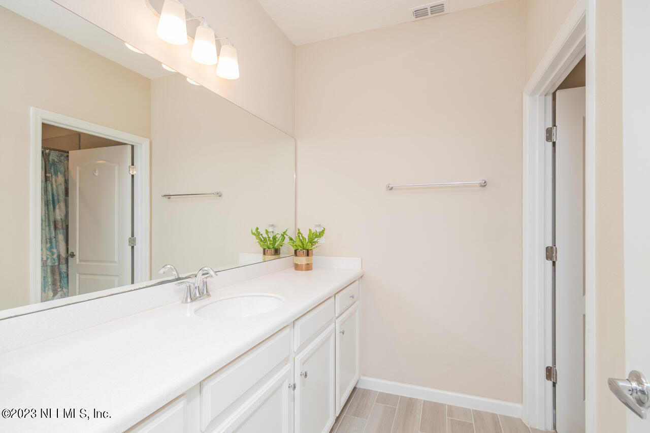 77 Glorieta Drive St. Augustine, FL 32095 - Photo 28 of 67 a bathroom with a sink and a mirror