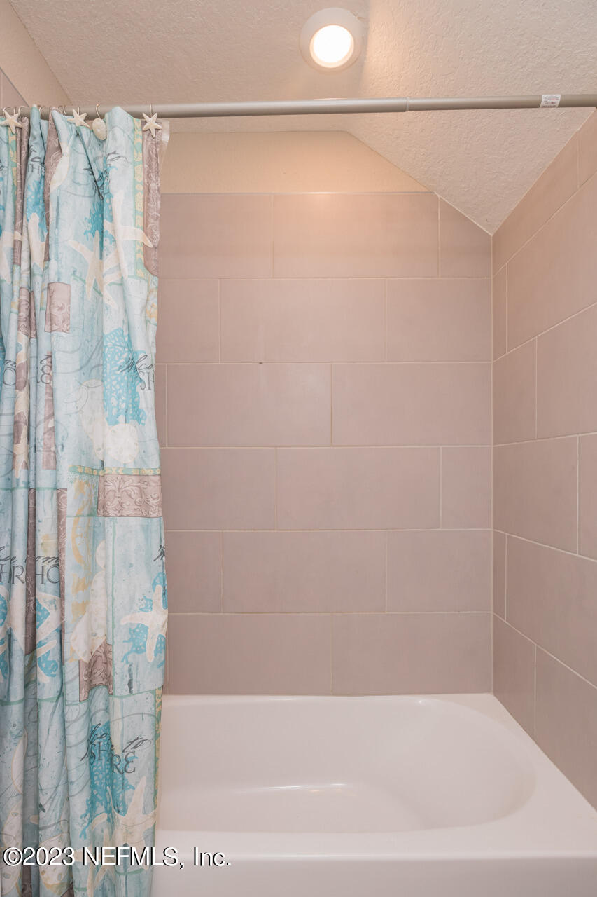 77 Glorieta Drive St. Augustine, FL 32095 - Photo 29 of 67 a bathroom with a shower and a bath tub