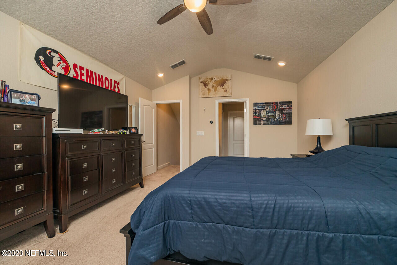 77 Glorieta Drive St. Augustine, FL 32095 - Photo 33 of 67 a bedroom with a bed and a flat tv screen on dresser