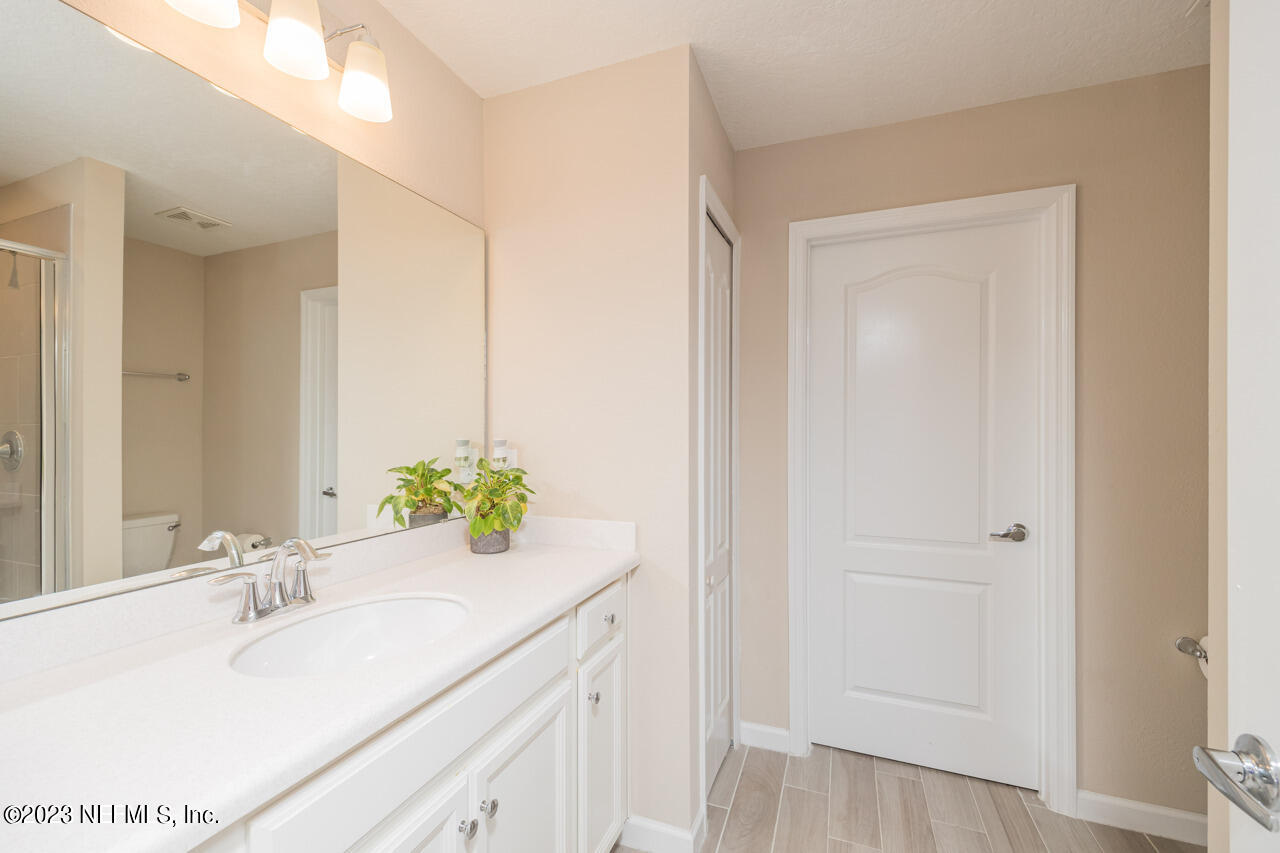 77 Glorieta Drive St. Augustine, FL 32095 - Photo 34 of 67 a bathroom with a sink and a mirror