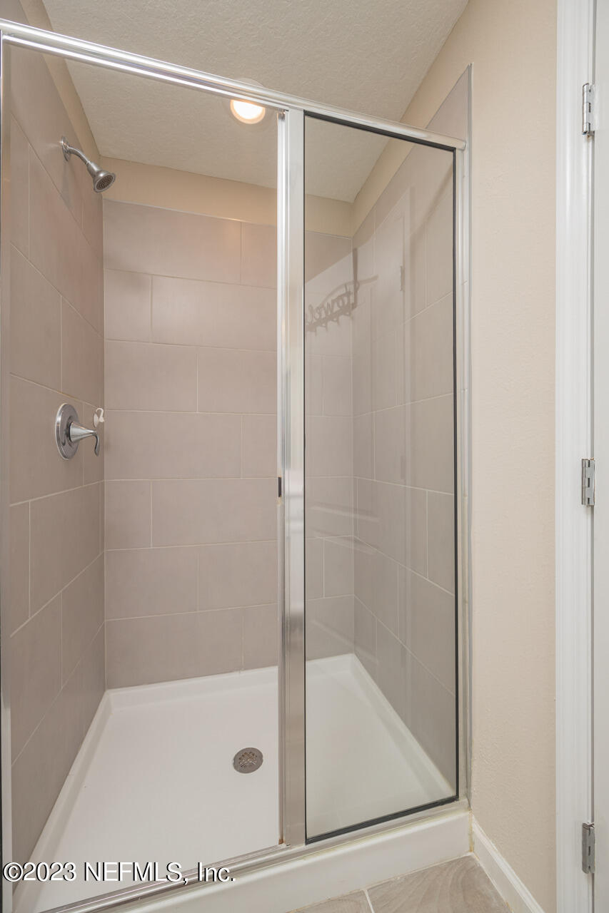 77 Glorieta Drive St. Augustine, FL 32095 - Photo 35 of 67 a bathroom with a glass shower door