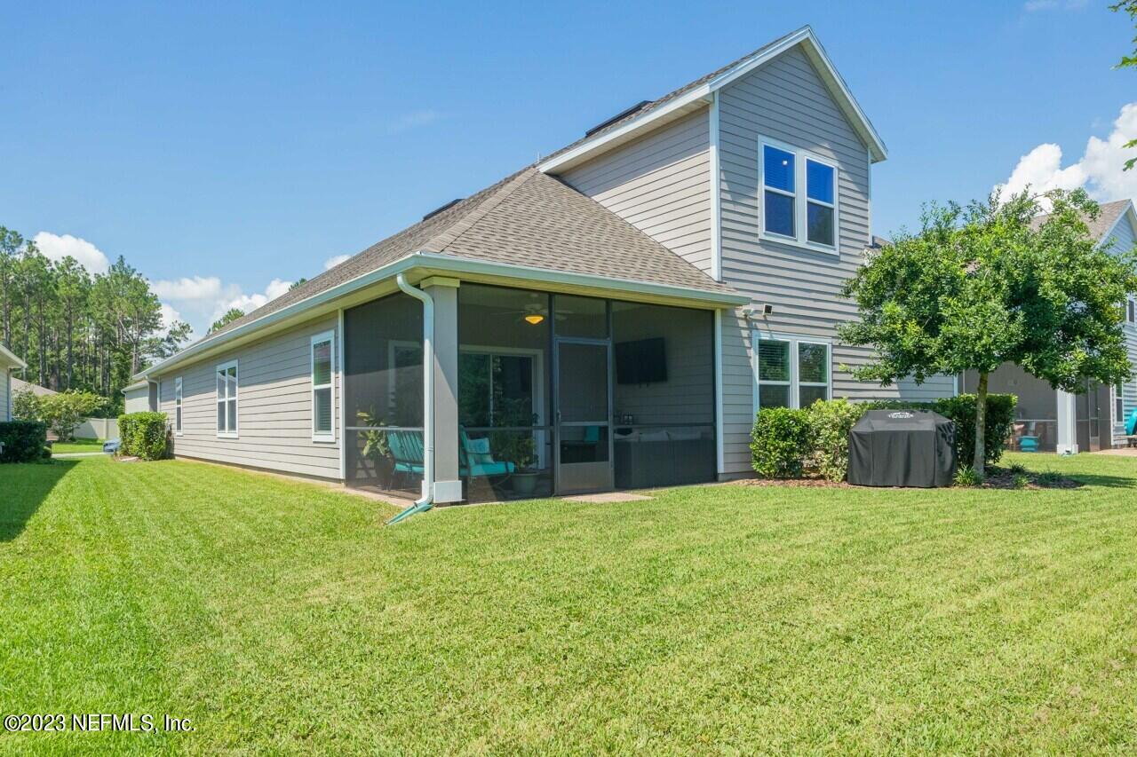 77 Glorieta Drive St. Augustine, FL 32095 - Photo 37 of 67 a front view of house with yard and glass windows